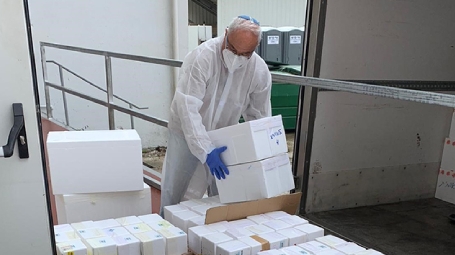 Prof. Robert Fluhr, director of the Nancy and Stephen Grand Israel National Center for Personalized Medicine at the Weizmann Institute of Science, receives the first shipment of tests arriving at the Weizmann Institute